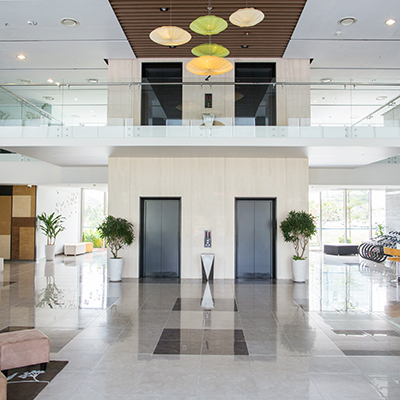 Empty lobby of condominium building. Elevators in hall of modern business center. Stylish interior design concept